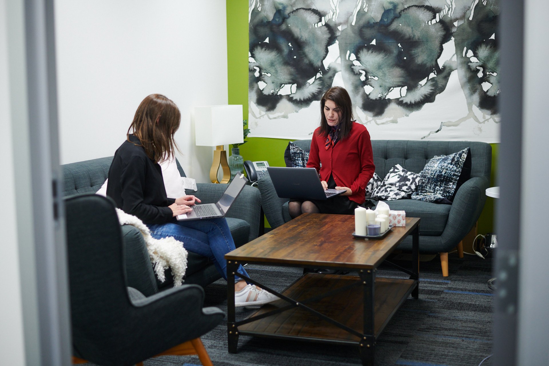 LyricFind employees working on laptops in a meeting room